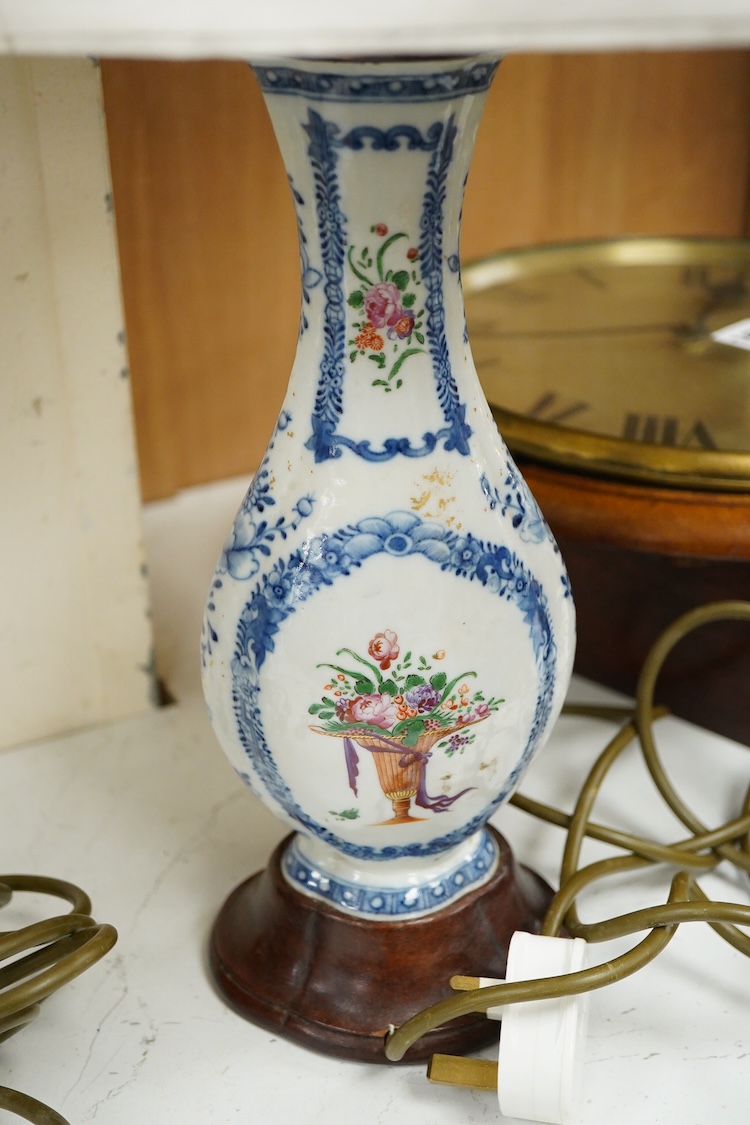 Two Chinese famille rose vases from a garniture, Qianlong period (1736-95), mounted as table lamps with shades, raised on shaped wood bases, overall 62cm high